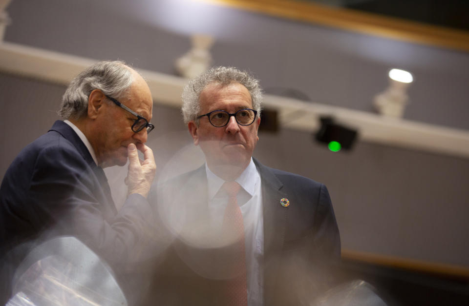 Luxembourg's Finance Minister Pierre Gramegna, right, speaks with Malta's Finance Minister Edward Scicluna during a meeting of EU finance ministers at the Europa building in Brussels, Tuesday, Feb. 18, 2020. EU finance ministers meet Tuesday to discuss tax havens. (AP Photo/Virginia Mayo)