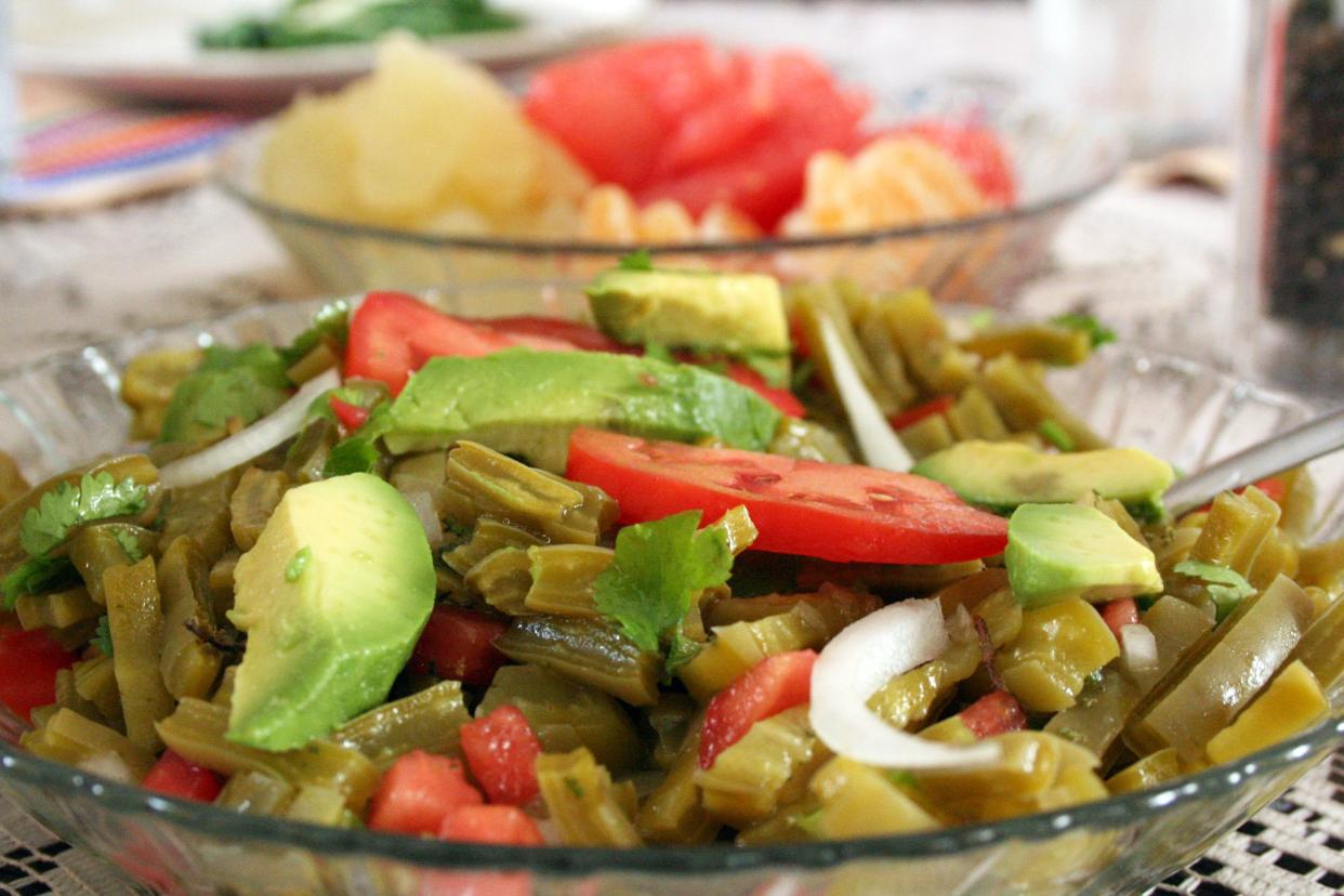 Nopal Salad in glass bowl with avocado, tomatoes, white onions