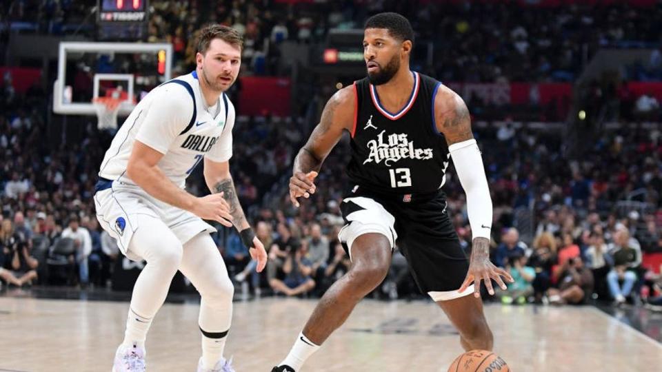 <div>Paul George #13 of the LA Clippers dribbles the ball against Luka Doncic #77 of the Dallas Mavericks .(Photo by Allen Berezovsky/Getty Images)</div> <strong>(Getty Images)</strong>