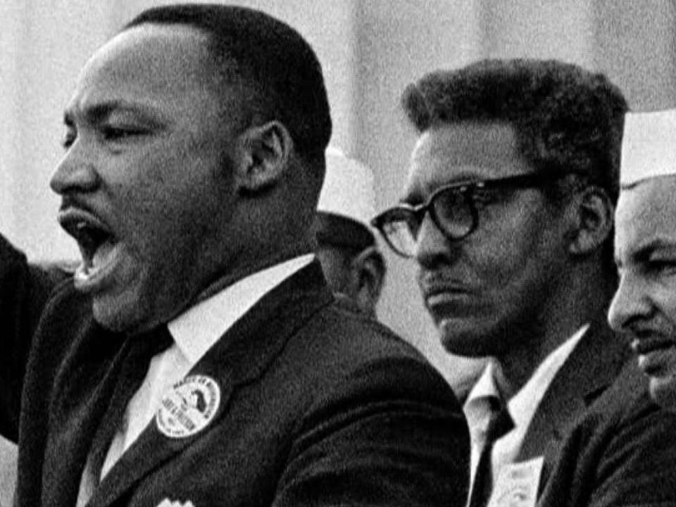 Bayard Rustin (right), organizer of the 1963 March on Washington for Jobs and Freedom, stands behind Dr. Martin Luther King Jr. on the steps of the Lincoln Memorial, August 28, 1963.  / Credit: Courtesy Bob Adelman Estate