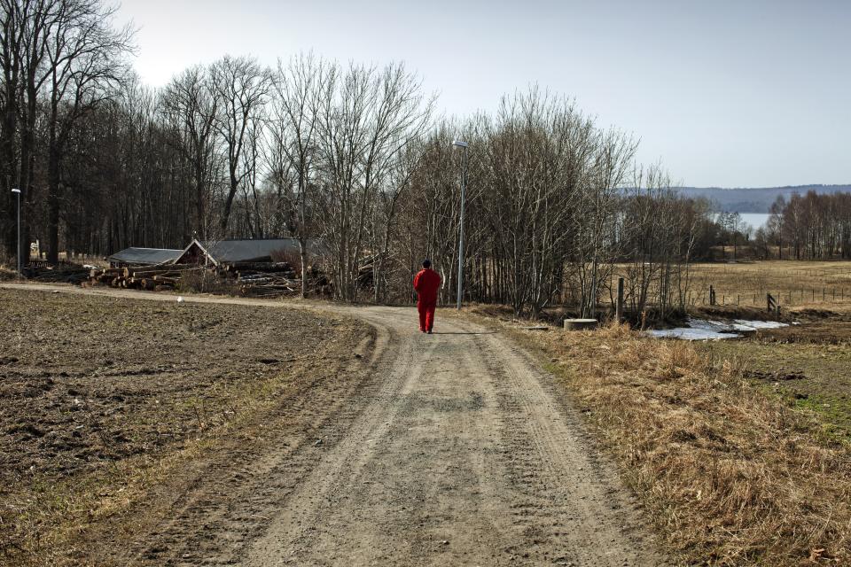 BASTOY ISLAND, HORTEN, NORWAY - APRIL 11:  An inmate is seen going for a walk around the island in Bastoy Prison on April 11, 2011 in Bastoy Island, Horten, Norway. Bastoy Prison is a minimum security prison located on Bastoy Island, Norway, about 75 kilometers (46 mi) south of Oslo. The facility is located on a 2.6 square kilometer (1 sq mi) island and hosts 115 inmates. Arne Kvernvik Nilsen, governor of the prison, leads a staff of about 70 prison employees. Of this staff, only five employees remain on the island overnight.  Once a prison colony for young boys, the facility now is trying to become 'the first eco-human prison in the world.' Inmates are housed in wooden cottages and work the prison farm. During their free time, inmates have access to horseback riding, fishing, tennis, and cross-country skiing. (Photo by Marco Di Lauro/Reportage by Getty Images)