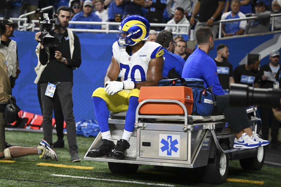 Rams offensive tackle Joe Noteboom (70) rides a cart to the locker room after being injured against the Detroit Lions.