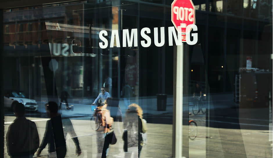 People walking by a Samsung Store.