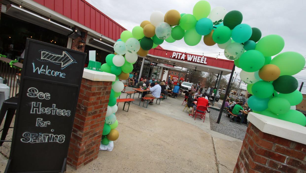People gathered inside and outside at Pita Wheel during the St. Patrick’s Day Celebration Saturday afternoon, March 13, 2021.