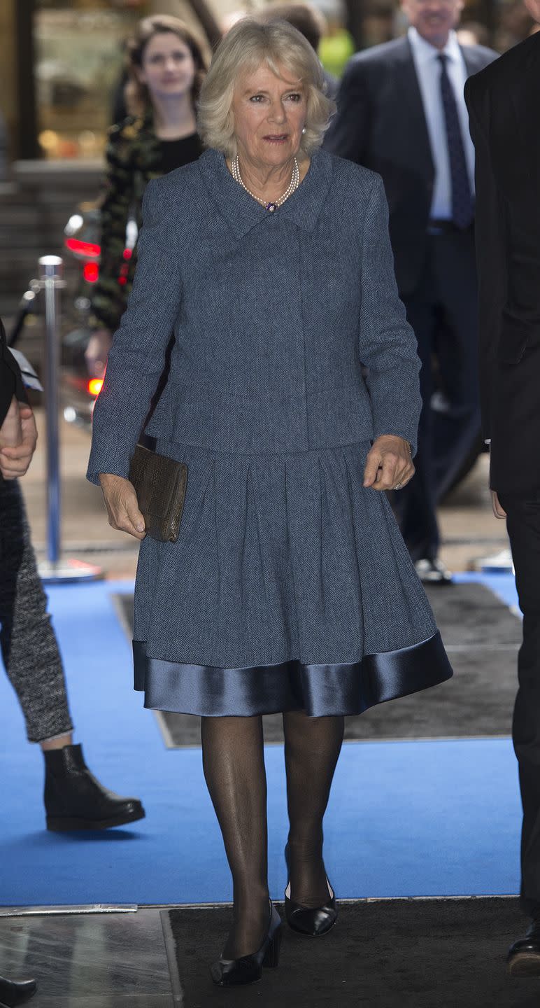 <p>Camilla wore a silk hemmed blue suit to visit ICAP for their 26th annual Charity Day. The Duchess paired the look with a pearl and sapphire necklace, drop earrings, and a brown clutch. </p>