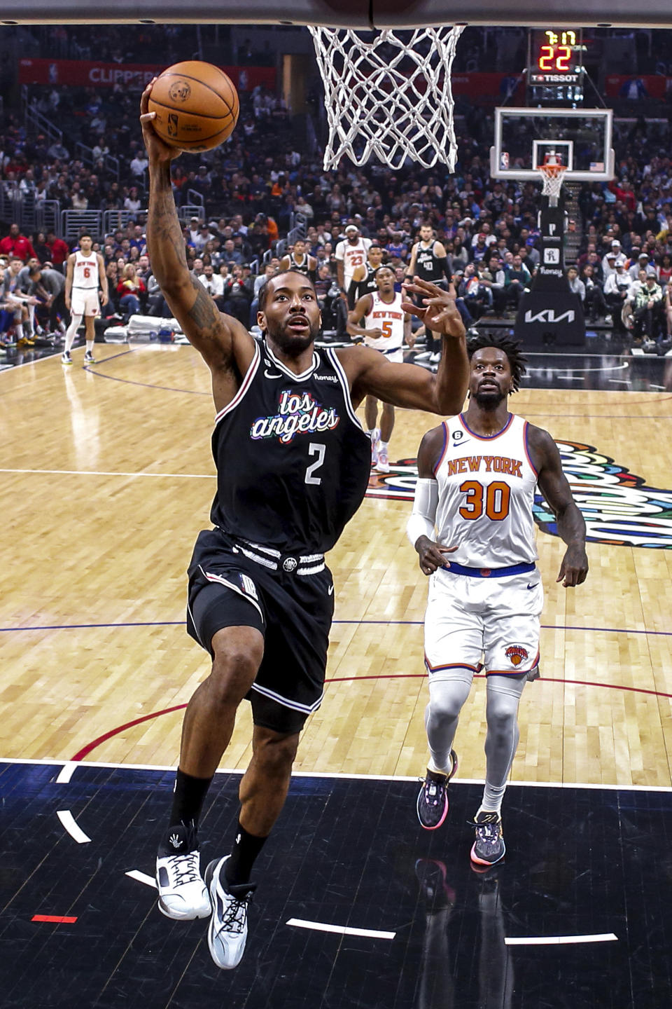 Los Angeles Clippers forward Kawhi Leonard (2) drives to basket as New York Knicks forward Julius Randle (30) looks on during the first half of an NBA basketball game Saturday, March 11, 2023, in Los Angeles. (AP Photo/Ringo H.W. Chiu)