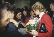 <p>Diana paid a visit to the AIDS unit of Harlem Hospital on her trip, wearing a red and white suit by Catherine Walker.</p>