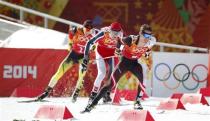 (R to L) Austria's Lukas Klapfer, Norway's Magnus Hovdal Moan and Germany's Eric Frenzel compete during the men's relay 4x5km cross-country race of the Nordic Combined team Gundersen event of the Sochi 2014 Winter Olympic Games, at the RusSki Gorki Ski Jumping Center in Rosa Khutor, February 20, 2014. REUTERS/Stefan Wermuth