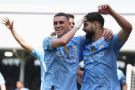 Manchester City's Josko Gvardiol, right, celebrates after scoring his side's third goal during the English Premier League soccer match between Fulham and Manchester City at the Craven Cottage Stadium in London, Saturday, May 11, 2024. (AP Photo/Kirsty Wigglesworth)