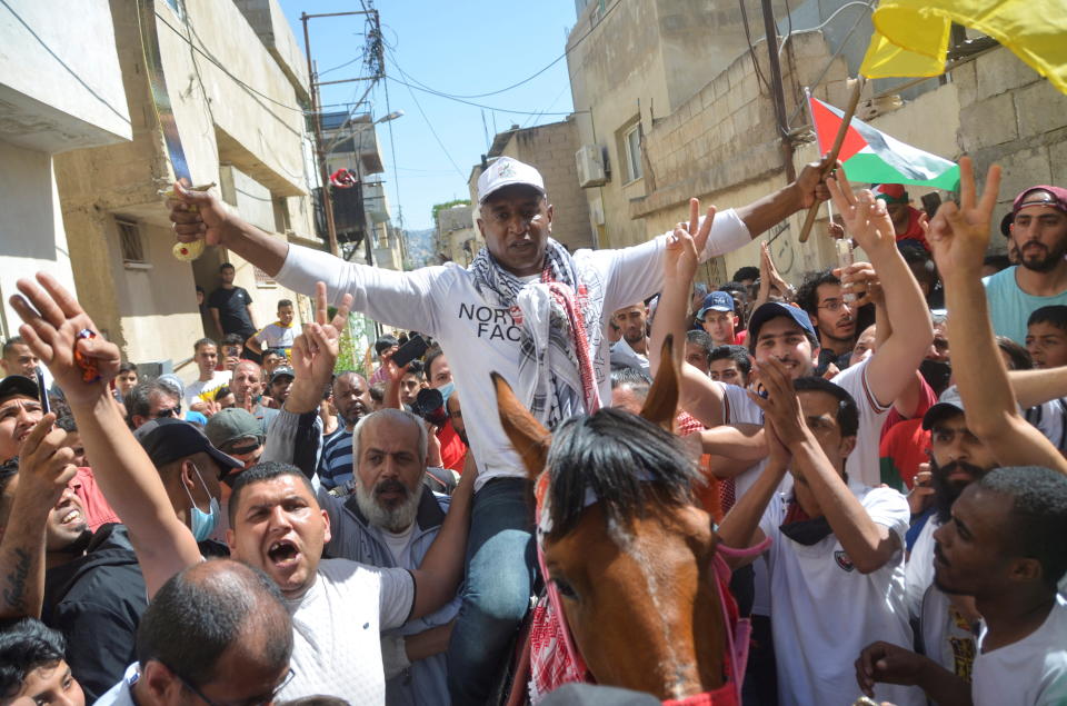 Abdullah Abu Jaber, longest serving Jordanian prisoner in Israeli jails, is welcomed after being released, as he arrives at Baqaa refugee camp, near Amman, Jordan, June 8, 2021. REUTERS/Muath Freij