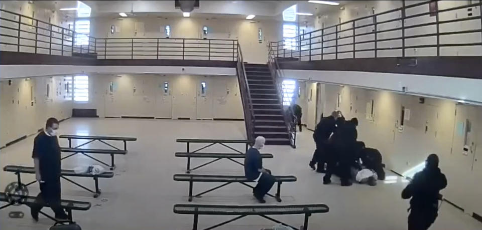 In this image made from video provided by the Ohio Department of Rehabilitation and Correction, prison guards escort Michael McDaniel, 55, in white shirt on the ground, to the medical facility at the Correctional Reception Center in Orient, Ohio. Ohio’s correctional agency has terminated seven employees after officials say prison guards used excessive and unjustified force against a Black inmate before he died in custody in February. The Ohio Department of Rehabilitation & Correction sent a notice of removal to five corrections officers, a supervisor and a licensed nurse following an investigation into the in-custody death of 55-year-old Michael McDaniel. (Ohio Department of Rehabilitation and Correction via AP)