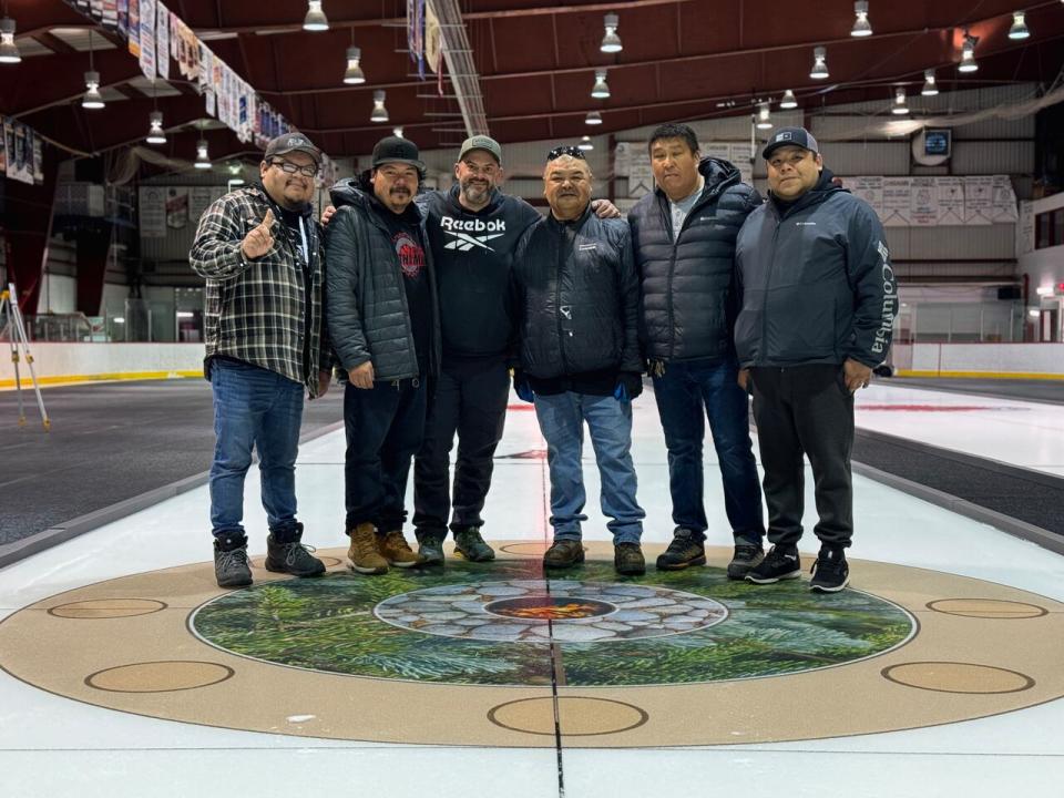 2021 Brier champion Darren Moulding, centre-left, has been teaching local community members how to make curling ice this week in Chisasibi.