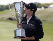 Zach Johnson of the U.S. kisses the trophy after winning the BMW Championship golf tournament at the Conway Farms Golf Club in Lake Forest, Illinois, September 16, 2013. REUTERS/Jim Young
