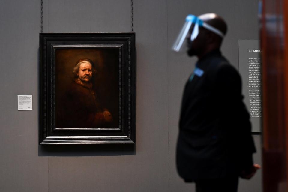 A member of staff at the National Gallery wears a visor as the building prepares to reopen to the public this week (Reuters)