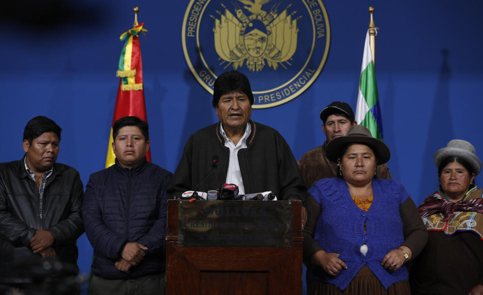 Bolivia's President Evo Morales, center, speaks during a press conference at the military base in El Alto, Bolivia, Sunday, Nov. 10, 2019. Hours later Morales announced his resignation under mounting pressure from the military and the public after his re-election victory triggered weeks of fraud allegations and deadly protests. (AP Photo/Juan Karita)