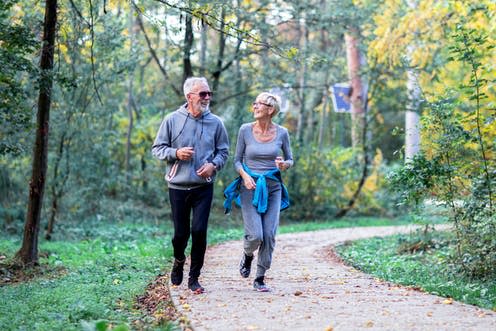 <span class="caption">Not only does exercise lower healthcare costs, it also lowers risk of disease.</span> <span class="attribution"><a class="link " href="https://www.shutterstock.com/image-photo/mature-couple-man-woman-jogging-park-1570816108" rel="nofollow noopener" target="_blank" data-ylk="slk:Zoran Pucarevic/ Shutterstock;elm:context_link;itc:0;sec:content-canvas">Zoran Pucarevic/ Shutterstock</a></span>