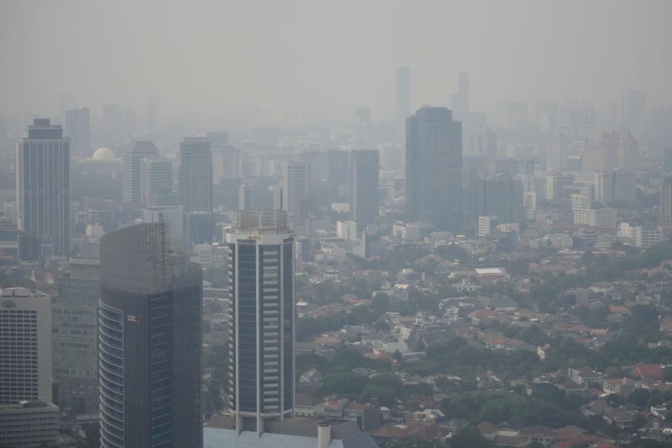 Haze blankets the main business district in Jakarta, Indonesia, on Aug. 11, 2023. A plan for how Indonesia will spend $20 billion to transition to cleaner energy was submitted Wednesday, Aug. 16, to the government and its financing partners, the planners said.