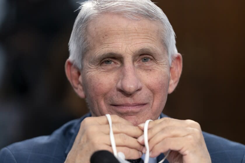 FILE - Dr. Anthony Fauci, Director of the National Institute of Allergy and Infectious Diseases, holds his face mask in his hands as he attends a House Committee on Appropriations subcommittee hearing on about the budget request for the National Institutes of Health, May 11, 2022, on Capitol Hill in Washington. Fauci, the government's top infectious disease expert, says he plans to retire by the end of President Joe Biden's term in January 2025. Fauci, 81, became director of the National Institute of Allergy and Infectious Diseases in 1984 and has advised seven presidents. (AP Photo/Jacquelyn Martin, File)