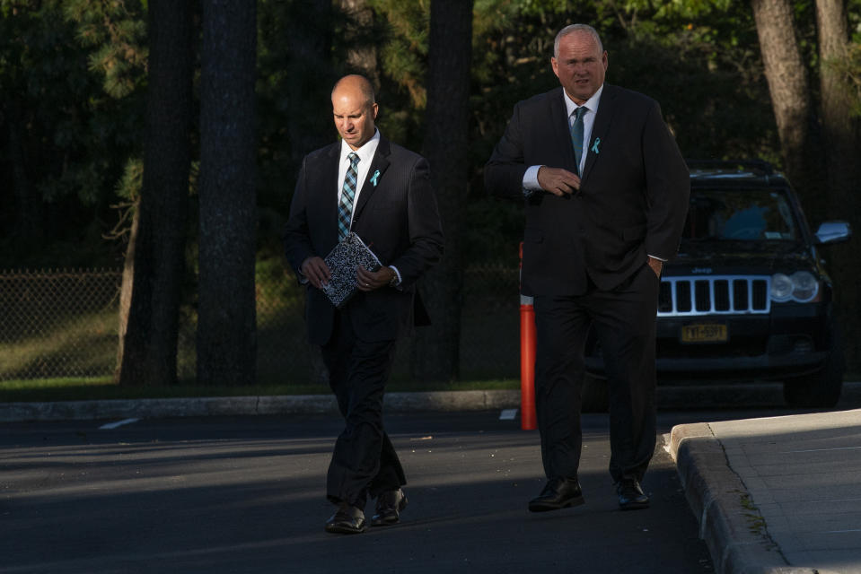 Gabby Petito's stepdad Jim Schmidt, left, exits Moloney's Funeral Home at the end of the funeral home viewing for Petito in Holbrook, N.Y. Sunday, Sept. 26, 2021. Lines of mourners paid their respects Sunday for Petito, the 22-year-old whose death on a cross-country trip has sparked a manhunt for her boyfriend. (AP Photo/Eduardo Munoz Alvarez)