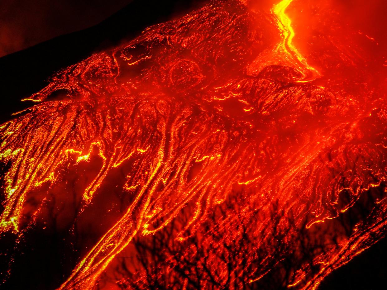 Large streams of red hot lava flow as Mount Etna, Europe's most active volcano, leaps into action, as seen from the village of Fornazzo (REUTERS)