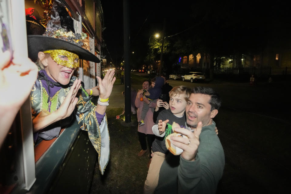 Members of the Mardi Gras group The Phunny Phorty Phellows revel on a street car for their annual kick off of the Mardi Gras season on Twelfth Night in New Orleans, Friday, Jan. 6, 2023. (AP Photo/Gerald Herbert)