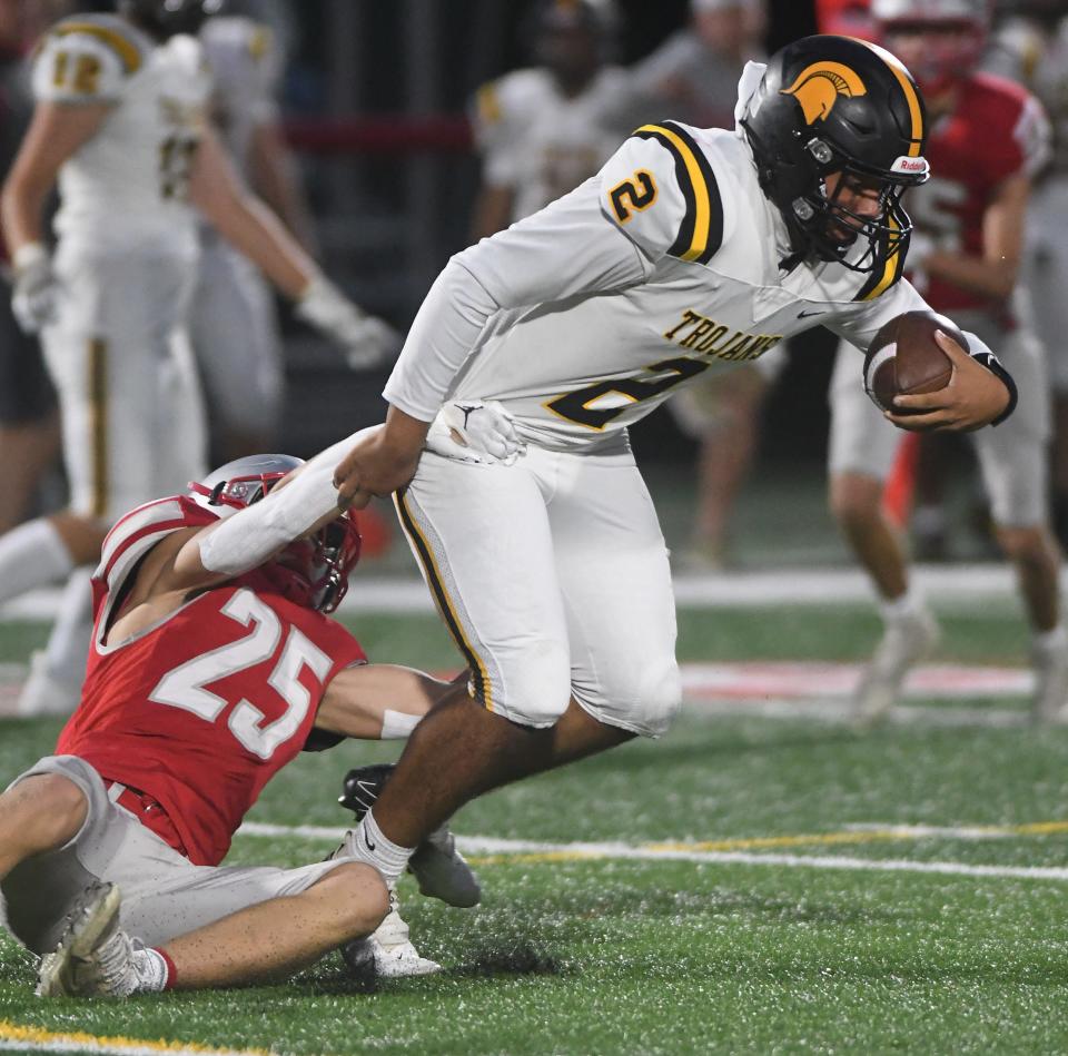 Greece Athena quarterback Jayden Rapp tries to break out of the grasp of Canandaigua defender Dominic Gullace in the second quarter.