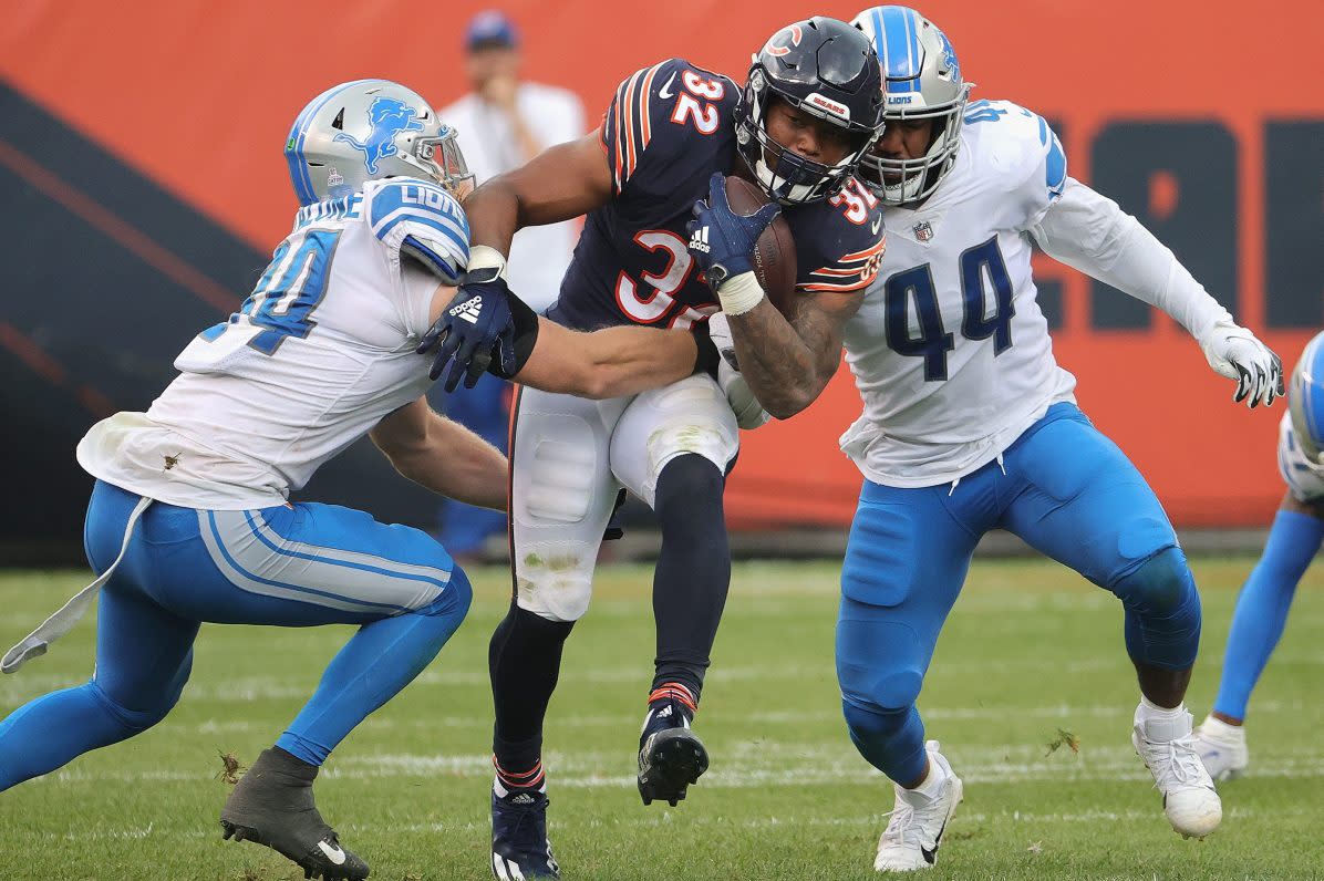 David Montgomery of the Chicago Bears tries to break away from Detroit defenders