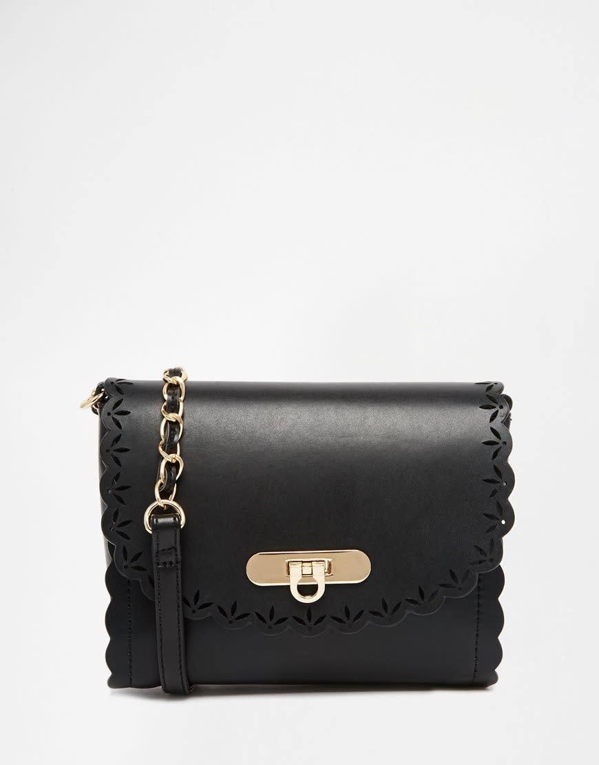 <p><i><a href="http://www.asos.com/asos/asos-scallop-cross-body-bag-with-laser-cut-out/prod/pgeproduct.aspx?iid=5907452&clr=Black&SearchQuery=bag&pgesize=36&pge=0&totalstyles=1710&gridsize=3&gridrow=1&gridcolumn=2" rel="nofollow noopener" target="_blank" data-ylk="slk:[ASOS, £16];elm:context_link;itc:0;sec:content-canvas" class="link ">[ASOS, £16]</a></i></p>