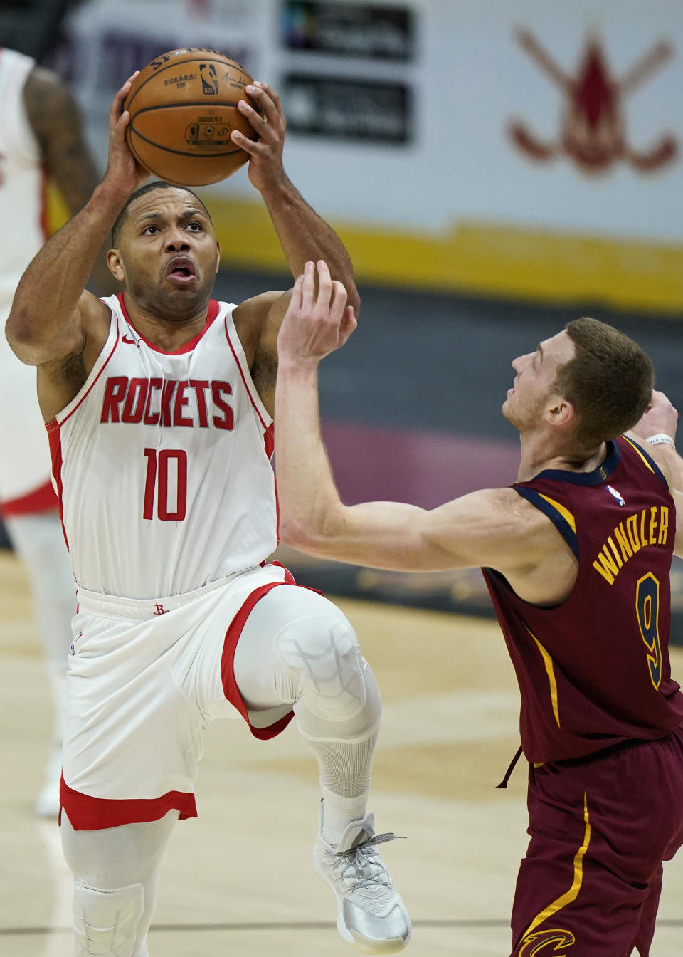 Houston Rockets' Eric Gordon (10) drives to the basket against Cleveland Cavaliers' Dylan Windler (9) in the second half of an NBA basketball game, Wednesday, Feb. 24, 2021, in Cleveland. The Cavaliers won 112-96. (AP Photo/Tony Dejak)