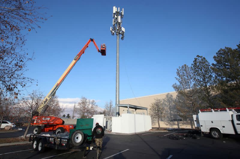 FILE PHOTO: A contract crew from Verizon installs 5G equipment on a tower in Orem