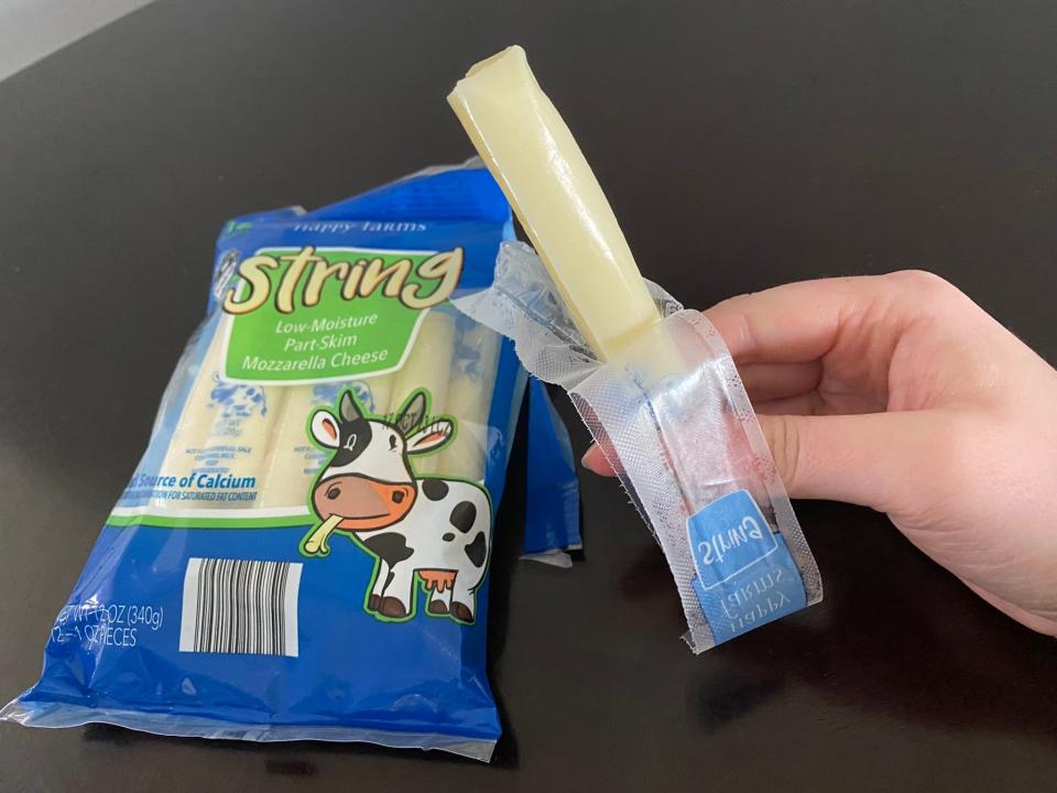 The writer with an open stick of Happy Farms string cheese