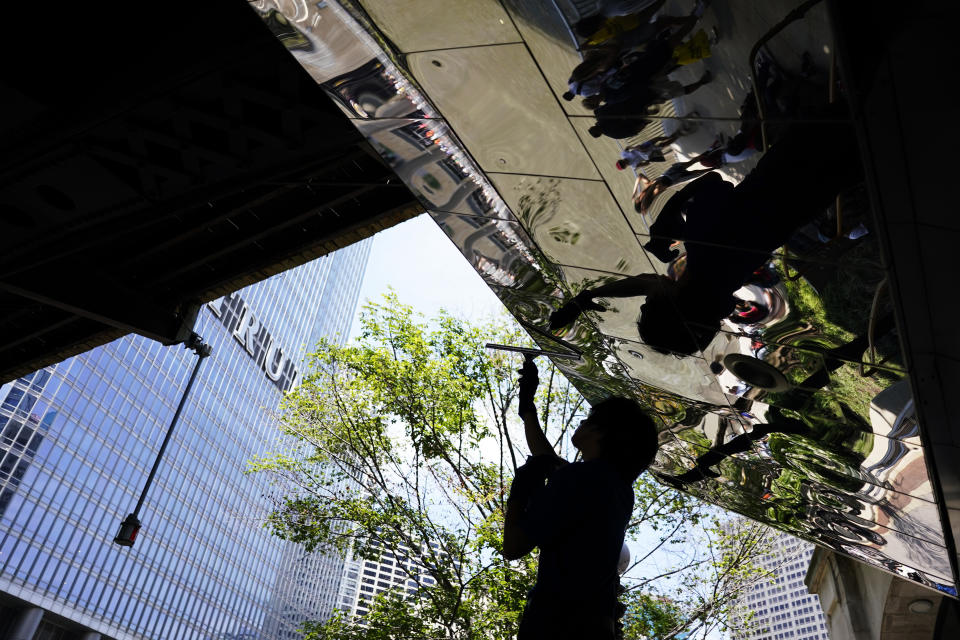 Ben Gallaido cleans the Chicago Riverwalk in Chicago, Monday, July 3, 2023, a day after heavy rains flooded Chicago streets and neighborhoods. (AP Photo/Nam Y. Huh)