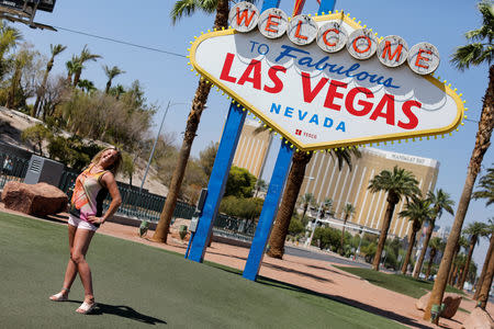 Tourists visit "The welcome to fabulous Las Vegas" sign in Las Vegas, Nevada, U.S., August 27, 2018. Picture taken August 27, 2018. REUTERS/Mike Blake