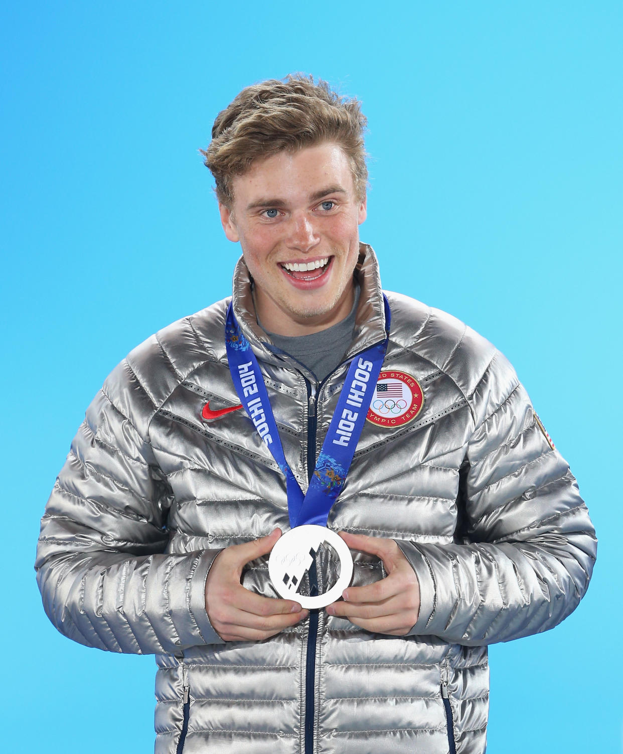 Silver medalist Gus Kenworthy holds his medal.