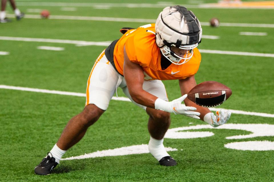 Tennessee linebacker Aaron Beasley (24) scoops up the ball during Tennessee football practice on Friday, August 12, 2022.