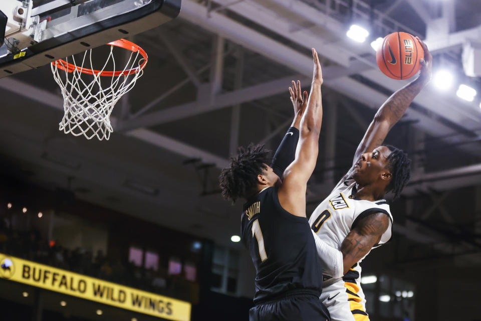 Virginia Commonwealth forward Jamir Watkins (0) tries to dunk on Vanderbilt forward Colin Smith (1) during the first half of an NCAA college basketball game Wednesday, Nov. 30, 2022, in Richmond, Va. (Shaban Athuman/Richmond Times-Dispatch via AP)