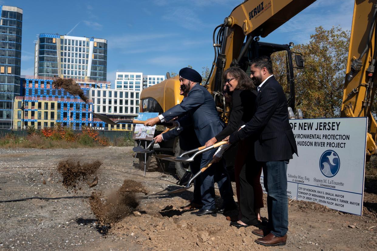 Oct 25, 2023; Hoboken, NJ, USA; (From right) Assemblyman Raj Mukherji, former Hoboken Mayor Dawn Zimmer, and Hoboken Mayor Ravi Bhalla during a ground breaking ceremony for the Rebuild by Design Meadowlands and Hudson River projects at Harborside Park. The projects include building floodwalls and pump stations among other infrastructure to prevent flooding in the area.