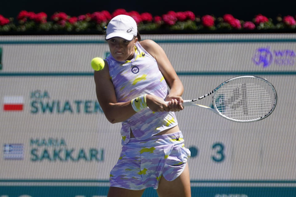 Iga Swiatek, of Poland, returns a shot to Maria Sakkari, of Greece, during the women's singles finals at the BNP Paribas Open tennis tournament Sunday, March 20, 2022, in Indian Wells, Calif. (AP Photo/Marcio Jose Sanchez)