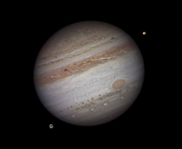 Winner (Solar System) and Overall Winner 'Jupiter with Io and Ganymede' by Damian Peach (UK) Jupiter depicted along with two of its 64 known moons, Io and Ganymede, showing the surface of the gas giant streaked with colourful bands and dotted with huge oval storms; detail is also visible on the two moons. The photos which make up this composite image were taken from Barbados where the excellent atmospheric clarity allows for exceptionally clear astronomical pictures.