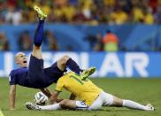 Arjen Robben of the Netherlands (L) is fouled by Brazil's Hernanes during their 2014 World Cup third-place playoff at the Brasilia national stadium in Brasilia July 12, 2014. REUTERS/Ueslei Marcelino (BRAZIL - Tags: SOCCER SPORT WORLD CUP)