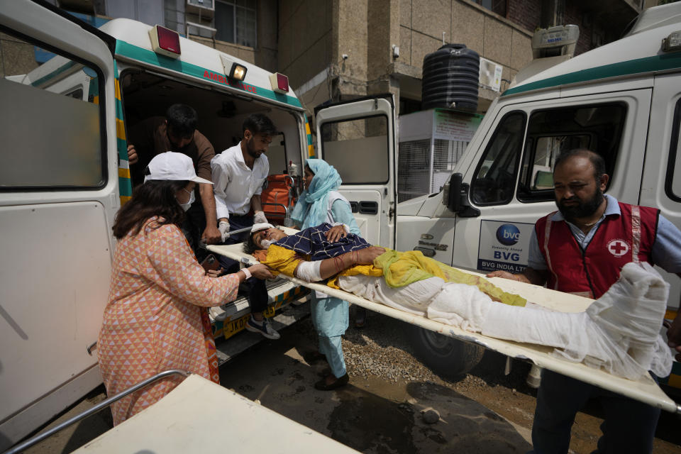 A passenger injured in a bus accident in Jammu and Kashmir's Poonch district is brought for treatment at a hospital in Jammu, India, Wednesday, Sept.14, 2022. Nearly a dozen people died and more people were injured when a mini-bus plunged into a deep gorge Wednesday. (AP Photo/Channi Anand)