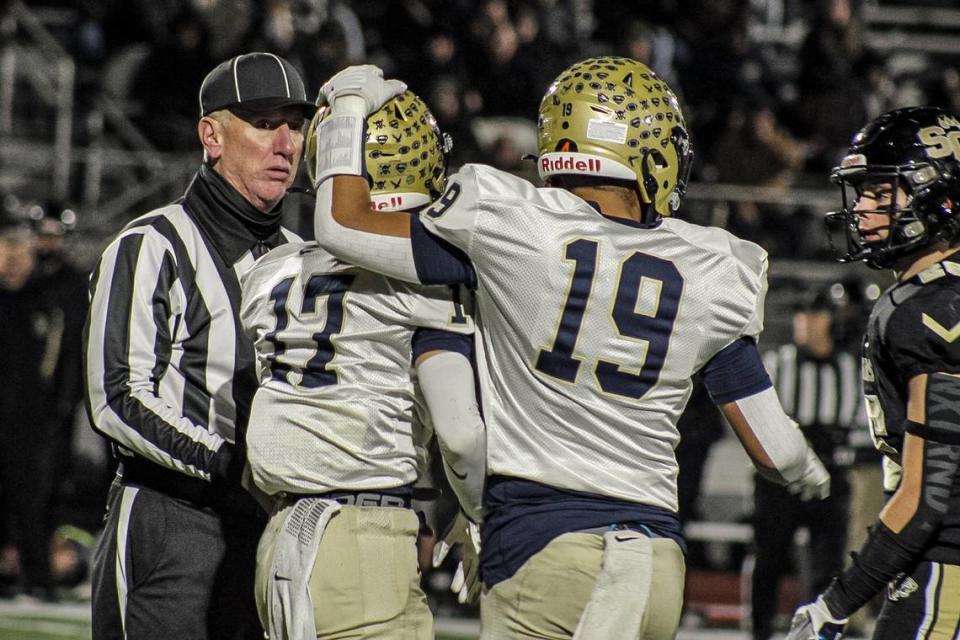 Bald Eagle Area’s Camron Watkins (19) pats teammate Gavin Burns on the helmet during the PIAA Class 2A quarterfinal against Southern Columbia on Friday. The Eagles fell to Southern Columbia, the reigning state champ, by a score of 18-8.