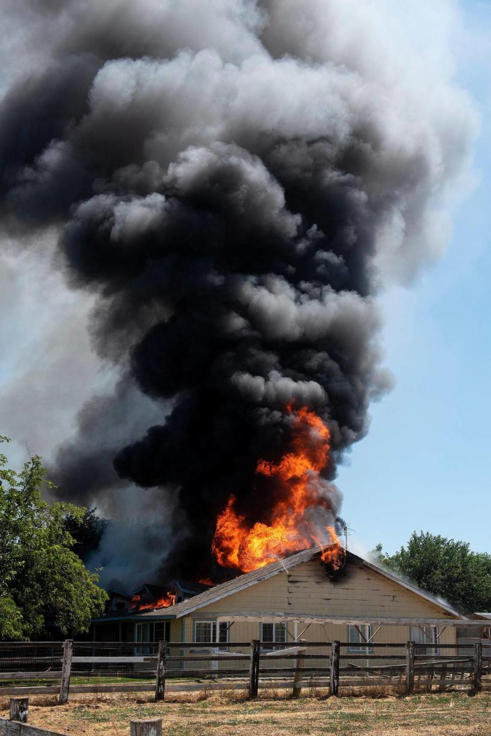 Cal Fire Merced County firefighters and City of Merced firefighters battle a structure fire which damaged two homes in the 1800 block of Dunn Road in Merced County, Calif., on Wednesday, Aug. 23, 2023. Fire officials said the cause of the fire is under investigation.