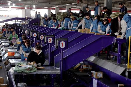 Workers sort parcels at a YTO Express logistics centre in Beijing, China, March 25, 2016. REUTERS/Jason Lee/File photo