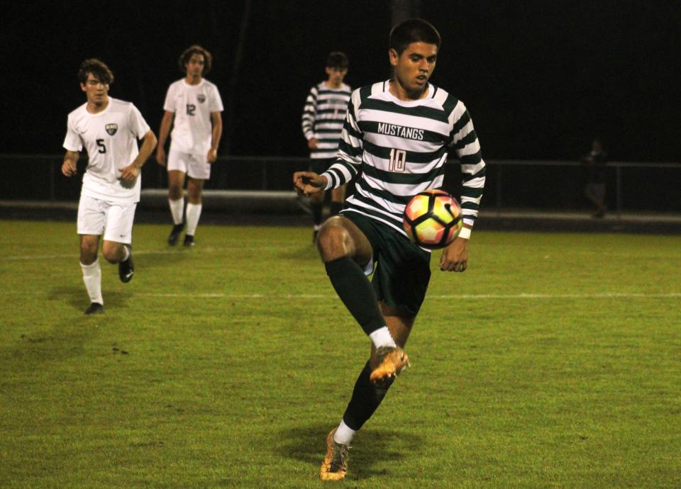 Mandarin midfielder Omar Trto (10) controls the ball against Bartram Trail.