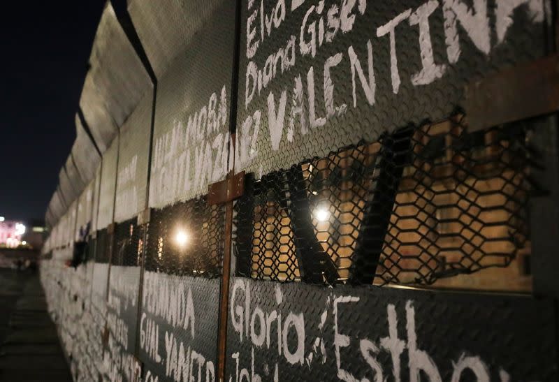 A view shows the names of victims of femicide in Mexico painted by women on fences placed outside the National Palace, in Mexico City