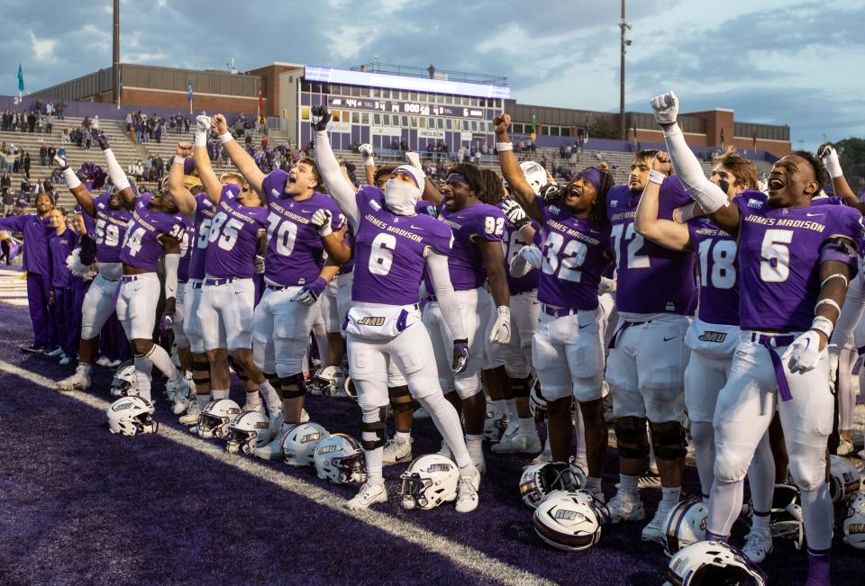 James Madison celebrates after defeating Connecticut during an NCAA college football game in Harrisonburg, Va., Saturday, Nov. 11, 2023. (Daniel Lin/Daily News-Record via AP) ORG XMIT: VAHAR120