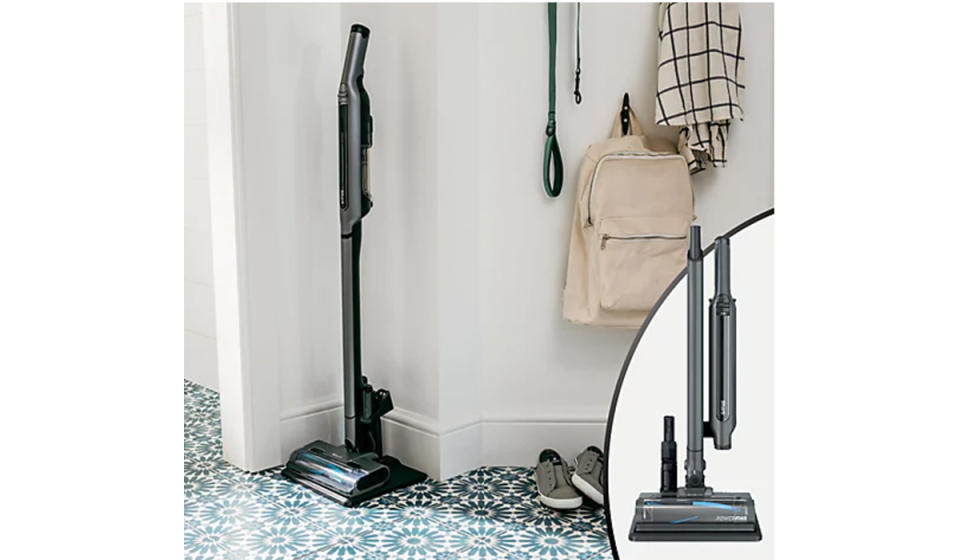 Shark WandVac shown tucked into a corner in the entryway assembled as a floor vac. An inset photo shows it held in 3 separate pieces on the charging base. 