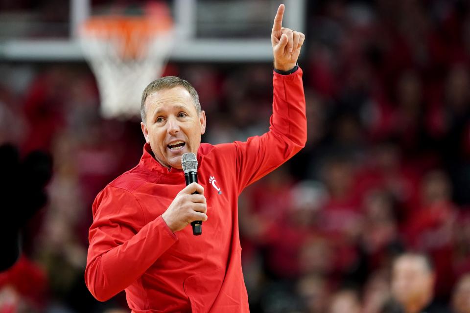 Cincinnati Bearcats head football coach Scott Satterfield speaks during a timeout in the first half of the 90th Crosstown Shootout college basketball game between the Xavier Musketeers and the Cincinnati Bearcats, Saturday, Dec. 10 at Fifth Third Arena.