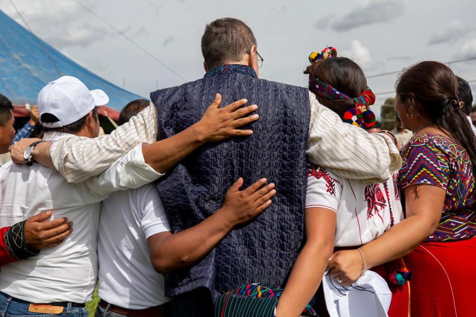 Then-presidential candidate Bernardo Arévalo, at center, takes photos with indigenous leaders during a private event held in Santa Cruz del Quiche, Guatemala, on Aug.11, 2023.